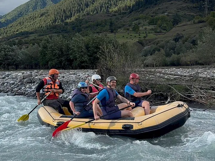 Crew paddling hard through white water on the Aragvi