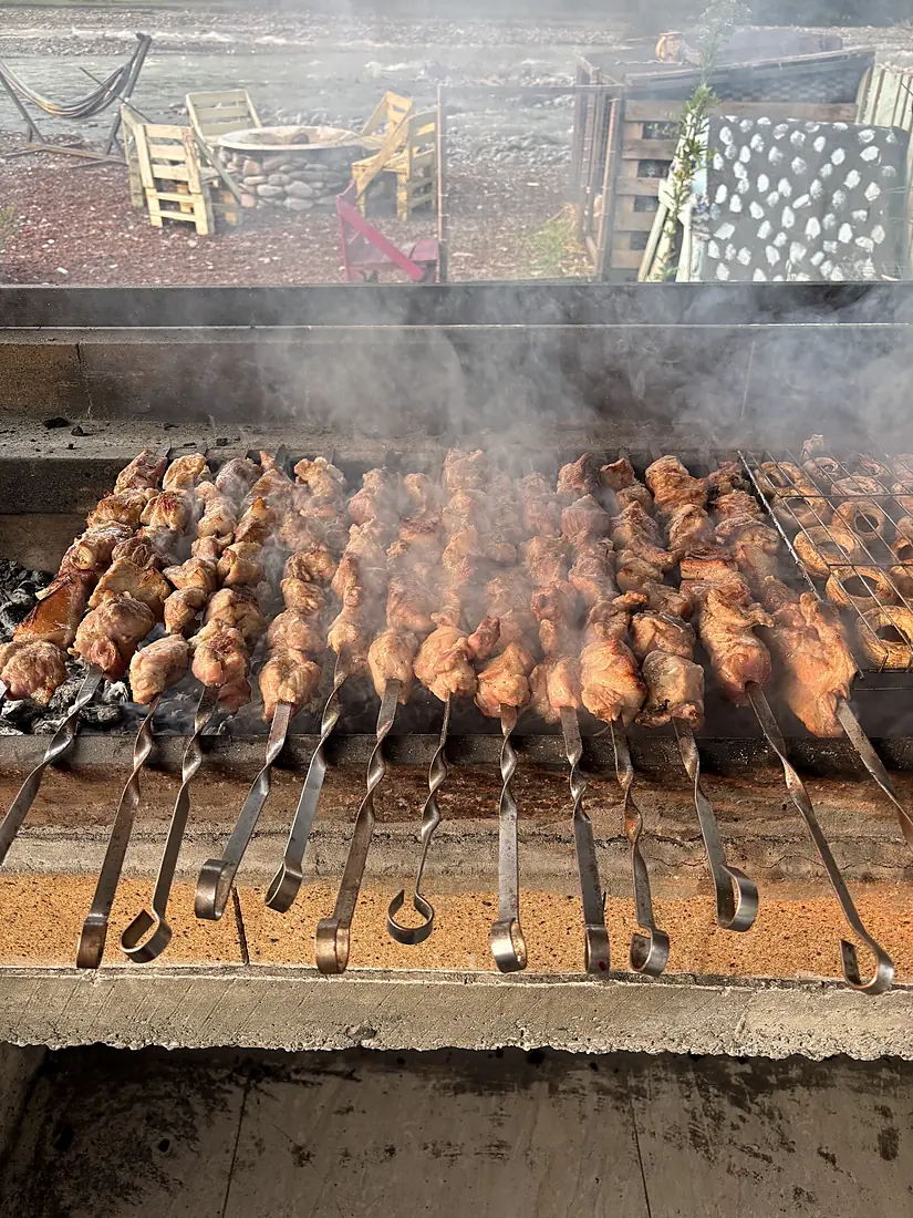 Mtsvadi skewers over the coals after a rafting run