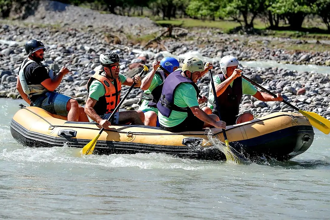 Raft crew splashing through white water