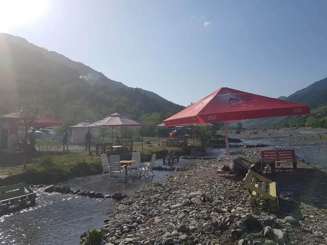 Riverside picnic area of the camp with umbrellas