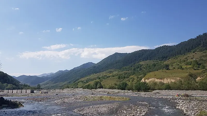 The White Aragvi river valley near Pasanauri with green mountain slopes