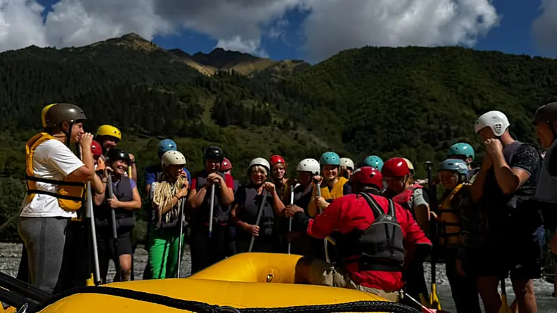Big group of rafters with helmets and life jackets lined up at the Raft in Georgia camp