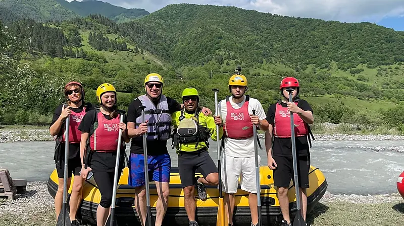 Rafting group with paddles and helmets at the Raft in Georgia camp on the White Aragvi